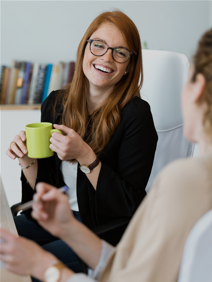 Woman drinking coffee and smiling